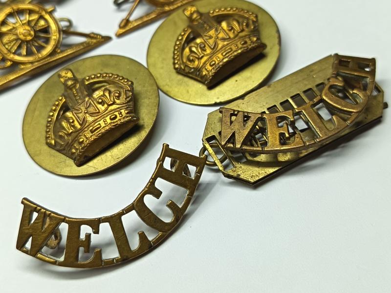 RA and Welch Regiment Brass Insignia.